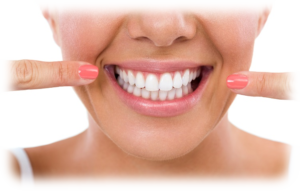 A young woman pointing proudly at herr white teeth.