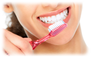 A young woman keeping her teeth white with good hygeine habits.