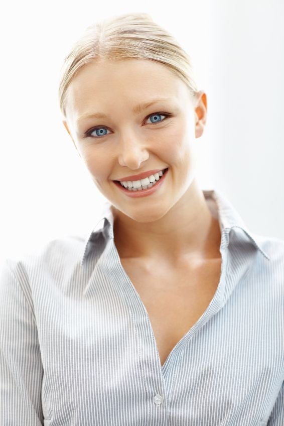 A young blonde woman grinning broadly after a smile makeover in Miami Springs.